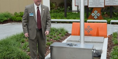 LGMC CEO Patrick Gandy prepares to bury the time capsule.