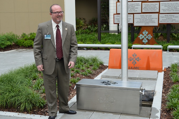 LGMC CEO Patrick Gandy prepares to bury the time capsule.